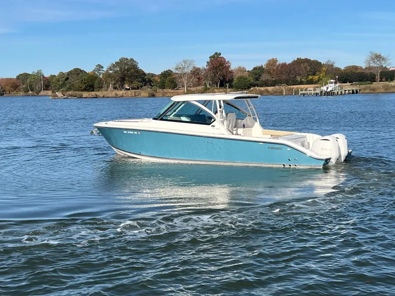 Slide: The Image of 2017 Pursuit 325 DC Dual Console boat cruising on a calm lake. - 32