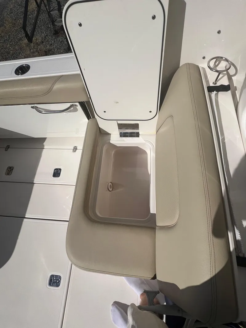 Slide: The Image of 2017 Pursuit 325 DC Dual Console boat interior with open storage compartment. - 35