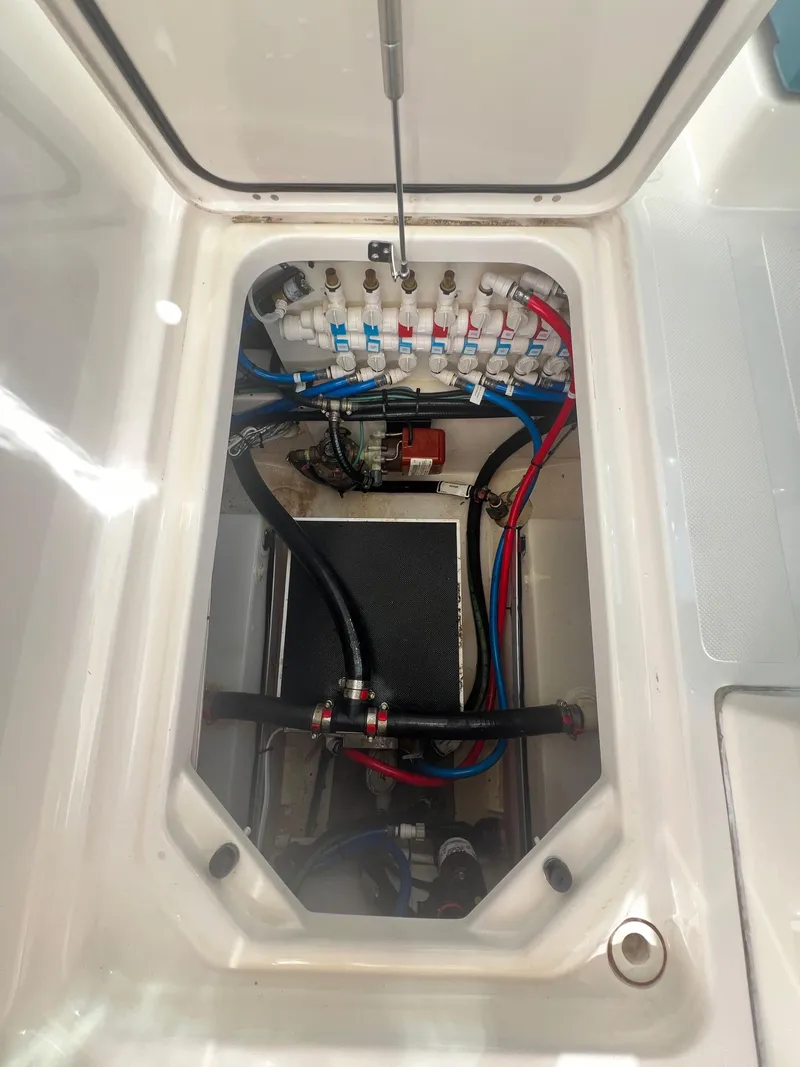 Slide: The Image of 2017 Pursuit 325 DC Dual Console boat wiring and plumbing compartment. - 36
