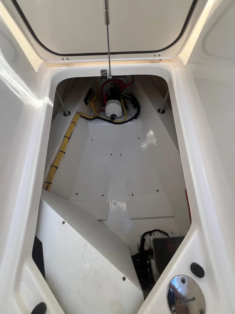 Slide: The Image of 2017 Pursuit 325 DC Dual Console storage compartment interior view. - 38