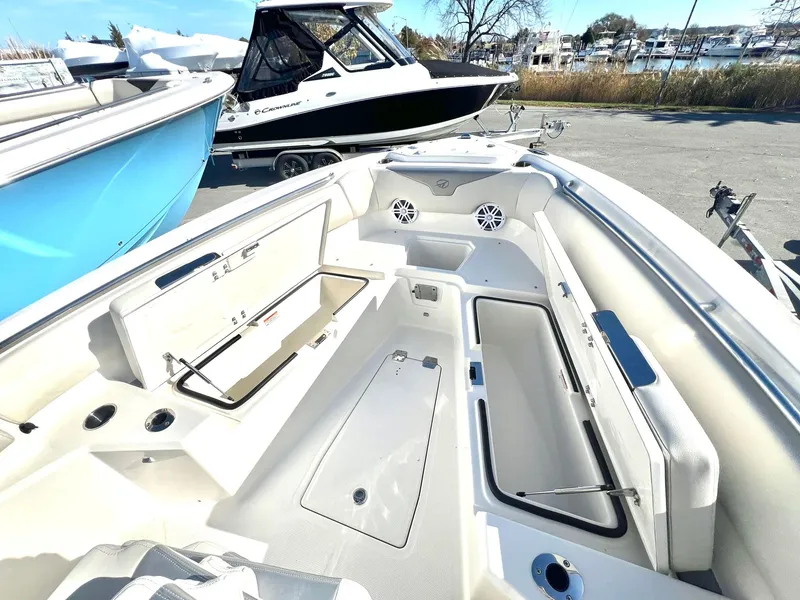 Slide: The Image of Sailfish 232 CC 2025 boat interior with storage compartment and speakers. - 12