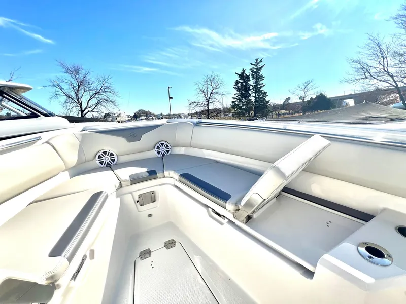 Slide: The Image of 2025 Sailfish 232 CC boat interior with seating and speakers under a clear blue sky. - 14