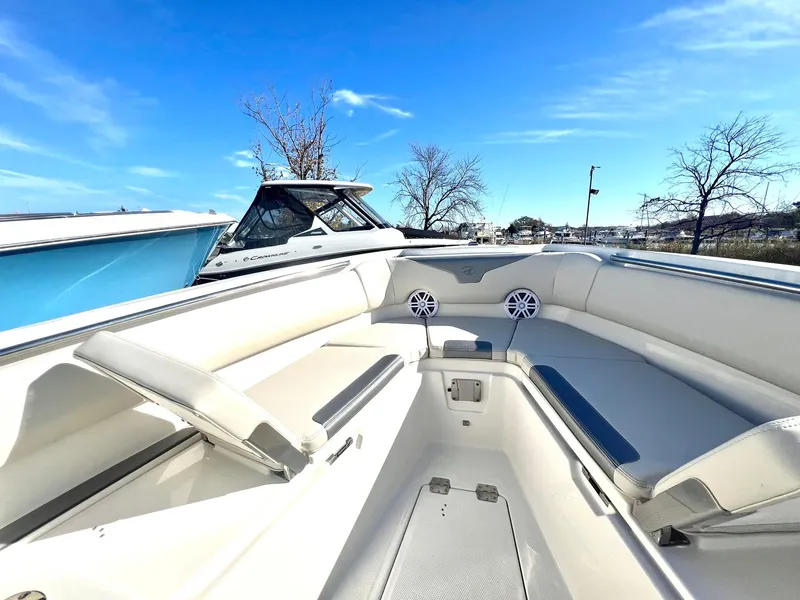 Slide: The Image of 2025 Sailfish 232 CC boat interior with white seating and clear blue sky. - 15