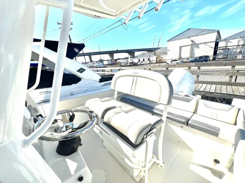 Slide: The Image of 2025 Sailfish 232 CC boat interior with spacious seating and storage compartments. - 2