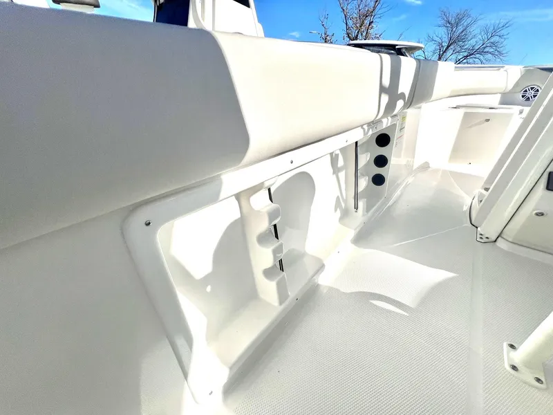 Slide: The Image of 2025 Sailfish 232 CC boat interior with white seating and storage compartments. - 22