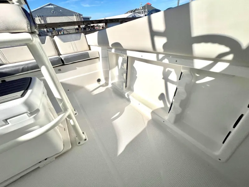 Slide: The Image of 2025 Sailfish 232 CC boat interior with seating and storage compartments. - 23