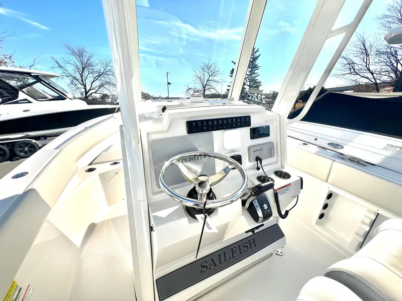 Slide: The Image of 2025 Sailfish 232 CC boat interior with storage compartment under clear blue sky. - 3