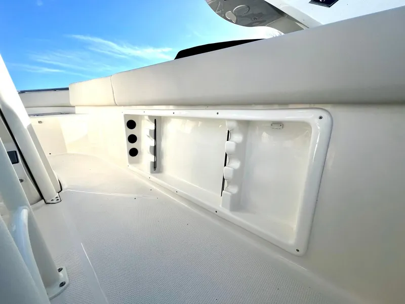 Slide: The Image of 2025 Sailfish 232 CC boat interior with fishing rod holders and storage compartments. - 7