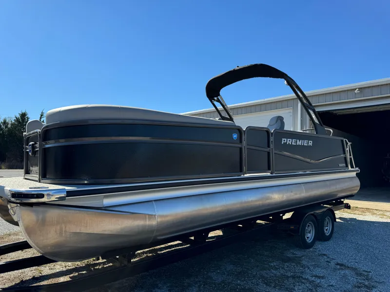 Slide: The Image of 2024 Premier 250 Sunsation pontoon boat on trailer, sleek black design. - 11