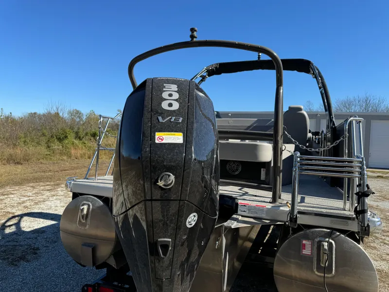 Slide: The Image of 2024 Premier 250 Sunsation pontoon boat with 300 V8 engine, rear view. - 13