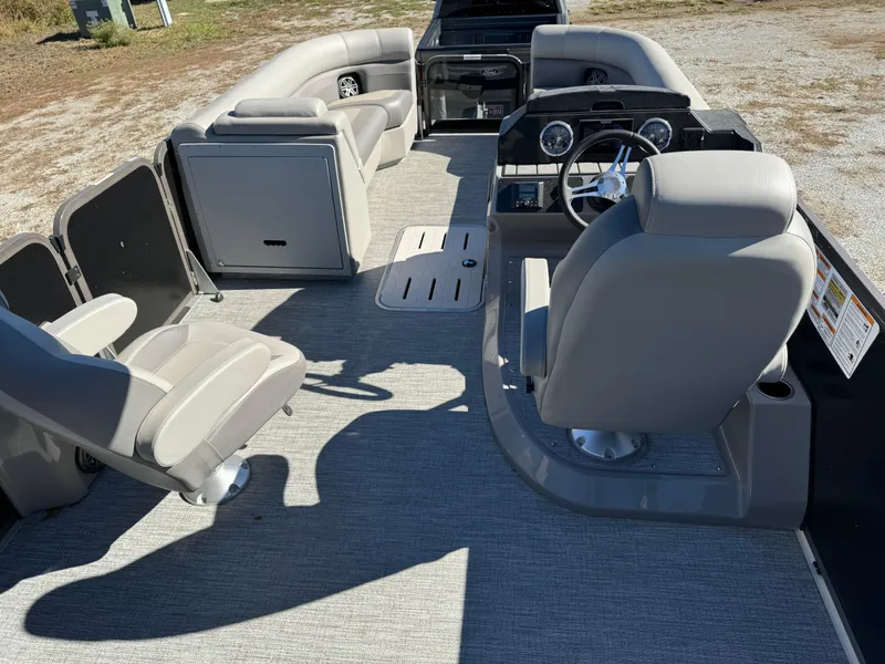 Slide: The Image of 2024 Premier 250 Sunsation pontoon boat interior with gray seating and steering console. - 14