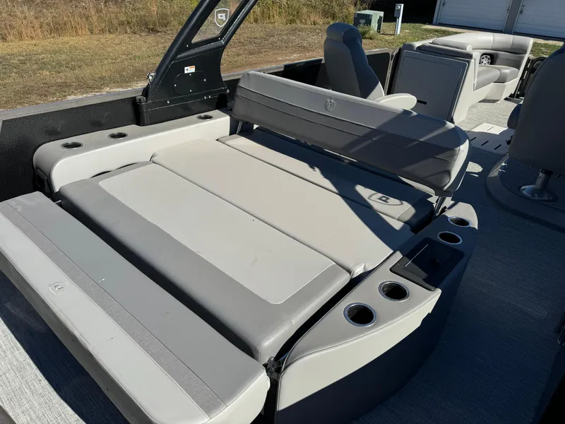 Slide: The Image of 2024 Premier 250 Sunsation boat interior with gray seating and cup holders. - 18