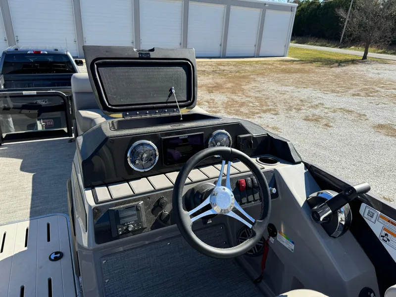 Slide: The Image of 2024 Premier 250 Sunsation boat dashboard with steering wheel and controls. - 21