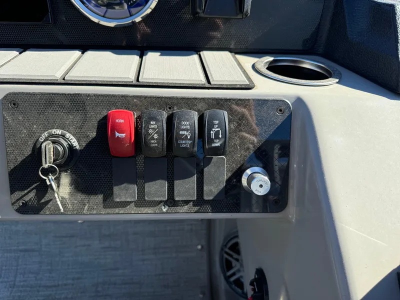 Slide: The Image of Control panel of 2024 Premier 250 Sunsation boat with ignition and switches. - 22
