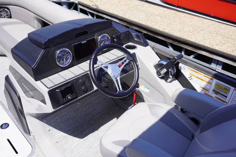 Slide: The Image of 2024 Premier 250 Sunsation boat dashboard with steering wheel and controls. - 4