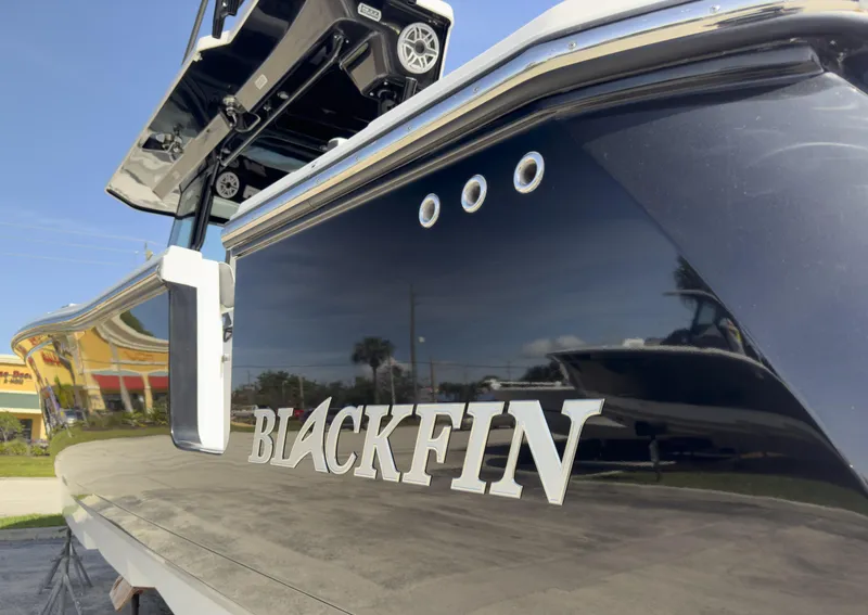 Slide: The Image of 2024 Blackfin 400 CC boat, sleek design with polished exterior and visible branding. - 22