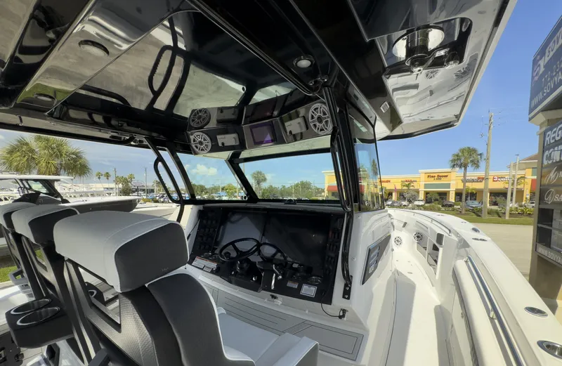 Slide: The Image of 2024 Blackfin 400 CC boat interior with modern dashboard and seating. - 25