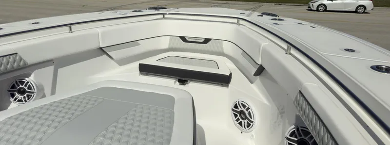 Slide: The Image of 2024 Blackfin 400 CC boat interior with cushioned seating and speakers. - 28