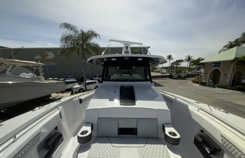 Slide: The Image of 2024 Blackfin 400 CC boat, docked, with sleek design and spacious deck. - 29