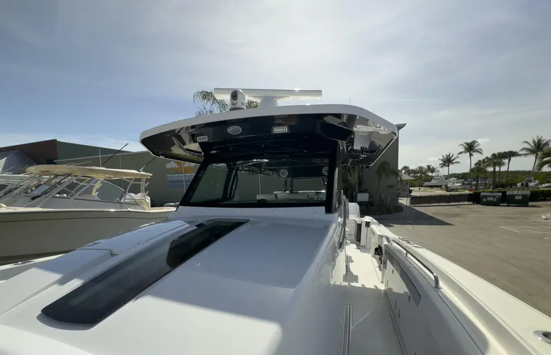 Slide: The Image of 2024 Blackfin 400 CC boat docked under clear sky, showcasing sleek design and modern features. - 32