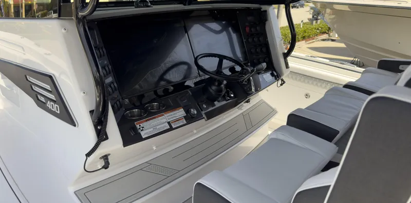 Slide: The Image of 2024 Blackfin 400 CC boat cockpit with dual steering wheels and modern controls. - 36