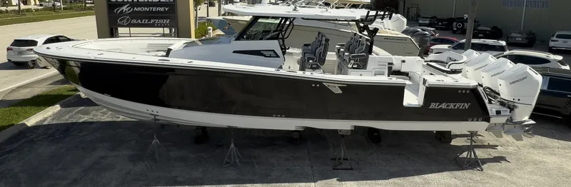 Slide: The Image of 2024 Blackfin 400 CC boat displayed outdoors on stands. - 4