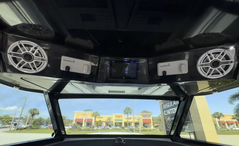 Slide: The Image of 2024 Blackfin 400 CC boat dashboard with Garmin speakers and display. - 48