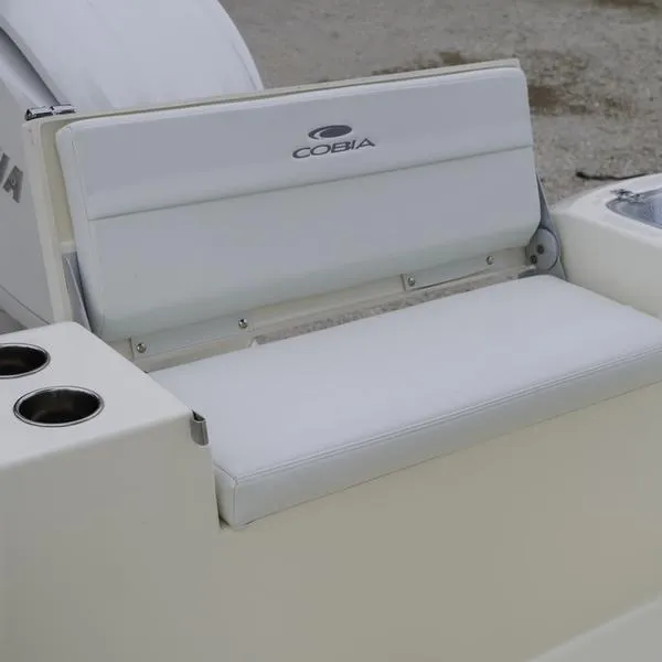 Slide: The Image of 2025 Cobia 220 Center Console boat seat with cup holders. - 11