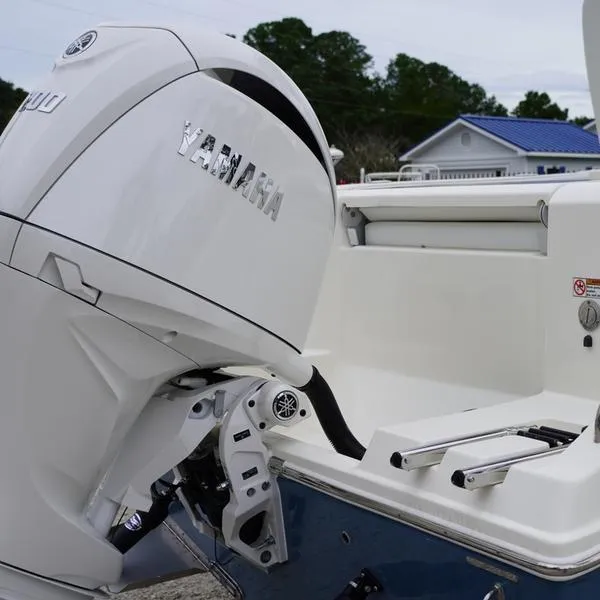Slide: The Image of 2025 Cobia 220 Center Console with Yamaha outboard motor, rear view. - 15