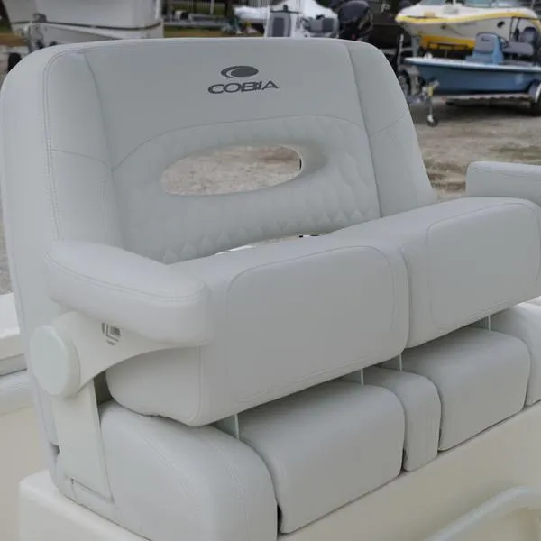 Slide: The Image of 2025 Cobia 220 Center Console boat seat, white upholstery, outdoor setting. - 6