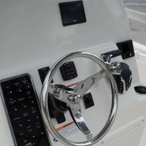 Slide: The Image of 2025 Cobia 220 Center Console steering wheel and control panel. - 8