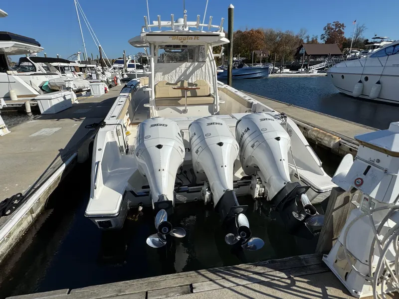 Slide: The Image of 2019 Pursuit S 368 Sport boat docked with triple Yamaha outboard engines. - 1