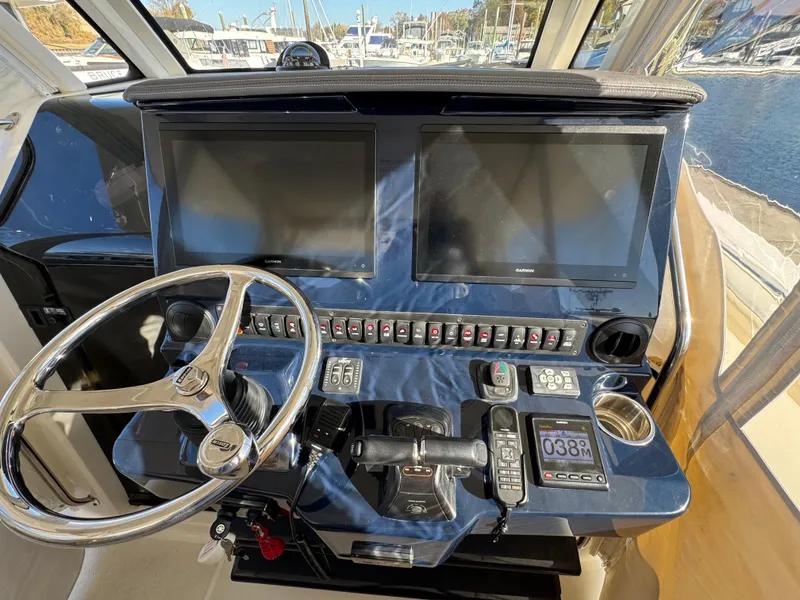 Slide: The Image of 2019 Pursuit S 368 Sport helm with dual screens and navigation controls. - 10