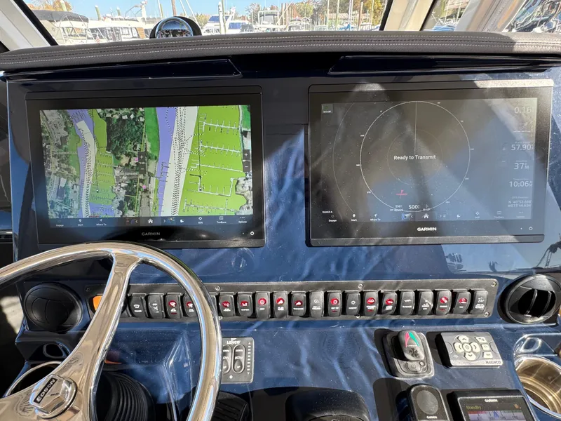 Slide: The Image of 2019 Pursuit S 368 Sport dashboard with navigation screens and controls. - 12