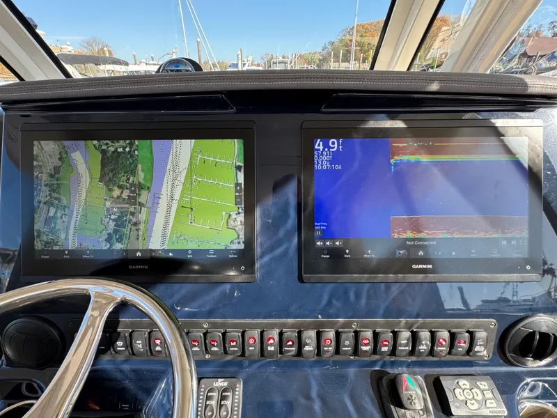 Slide: The Image of Dashboard of a 2019 Pursuit S 368 Sport boat with dual Garmin displays. - 13