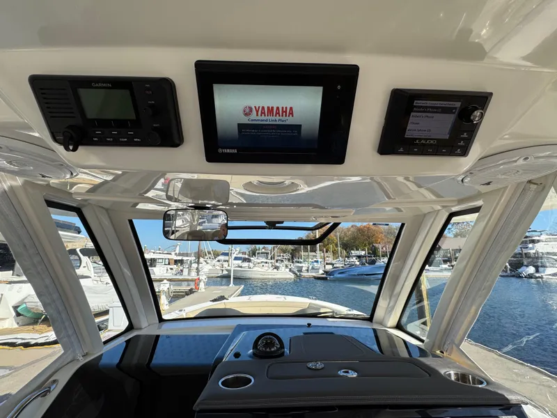 Slide: The Image of 2019 Pursuit S 368 Sport boat dashboard with Yamaha display at marina. - 14