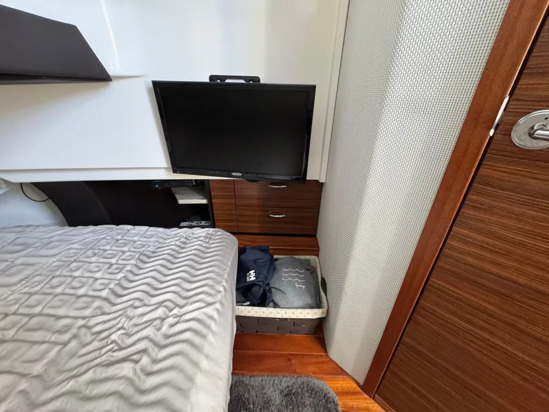 Slide: The Image of Cozy cabin interior of 2019 Pursuit S 368 Sport with TV, bed, and storage. - 18