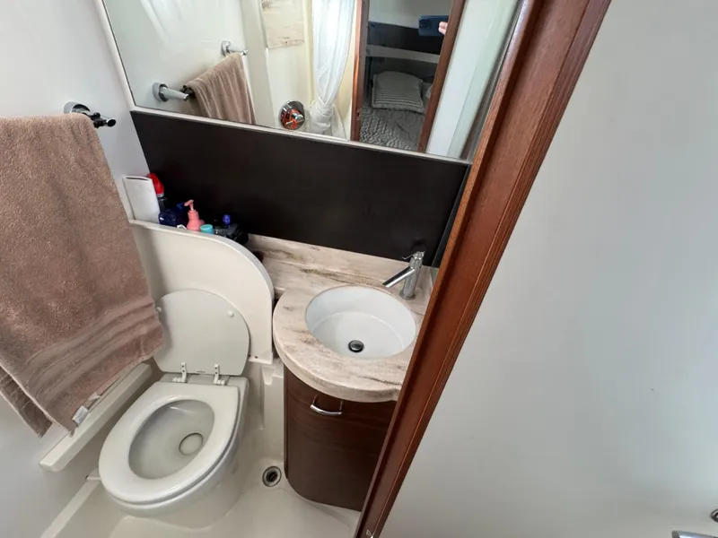 Slide: The Image of 2019 Pursuit S 368 Sport boat bathroom with sink, toilet, and towel. - 19