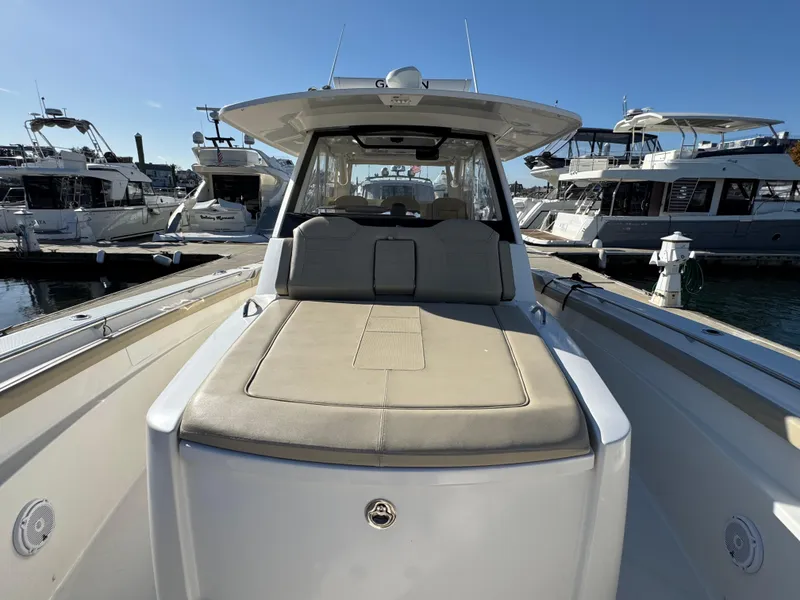 Slide: The Image of 2019 Pursuit S 368 Sport boat docked, featuring spacious deck and seating area. - 21