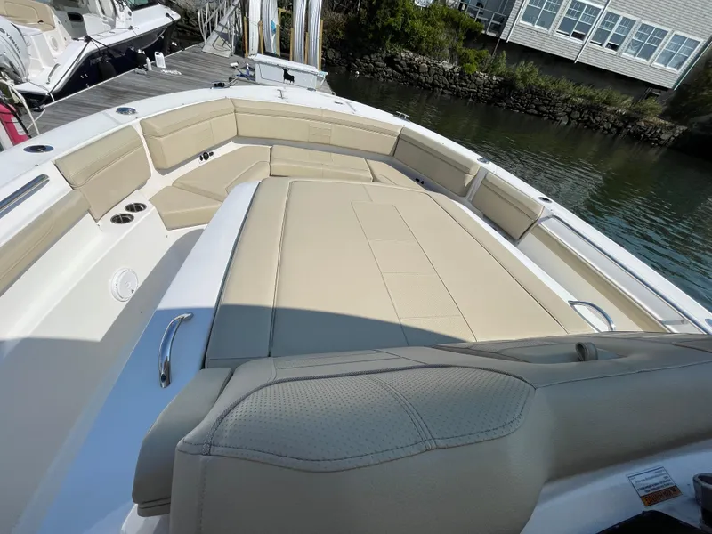 Slide: The Image of 2019 Pursuit S 368 Sport boat with beige seating and spacious deck area. - 29