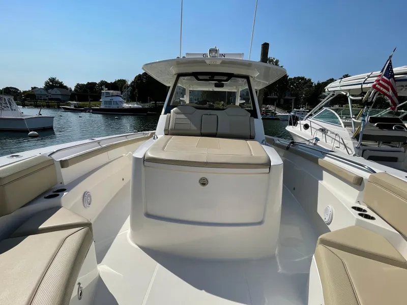 Slide: The Image of 2019 Pursuit S 368 Sport boat docked in a sunny marina. - 30