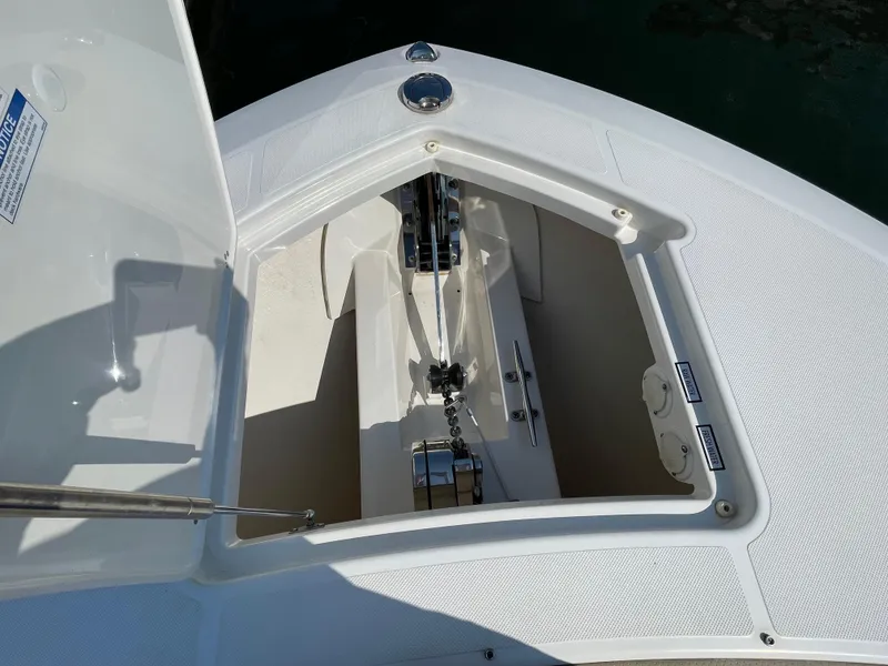 Slide: The Image of 2019 Pursuit S 368 Sport boat anchor compartment, open hatch, white interior. - 31