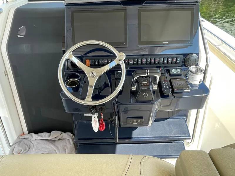 Slide: The Image of 2019 Pursuit S 368 Sport boat helm with dual screens and steering wheel. - 32