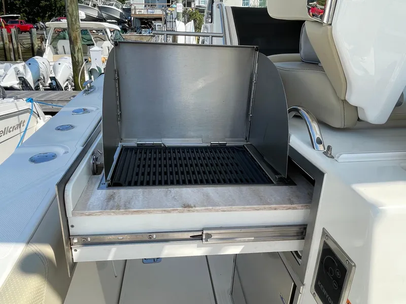 Slide: The Image of Outdoor grill on 2019 Pursuit S 368 Sport boat, featuring stainless steel design. - 36