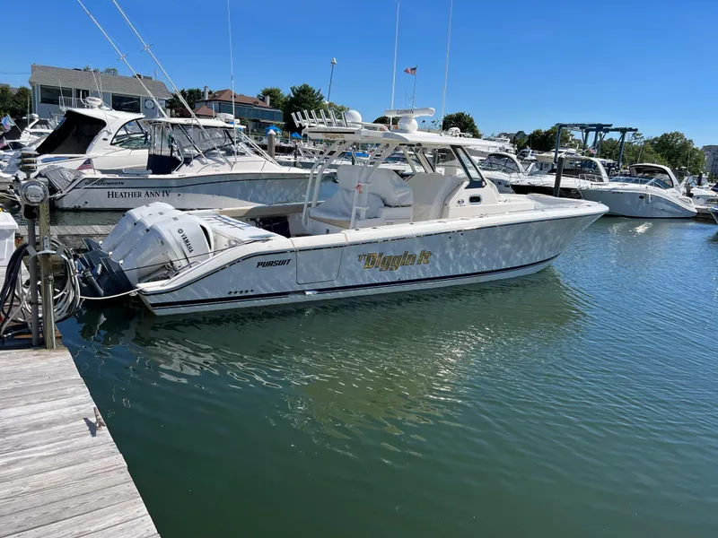 Slide: The Image of 2019 Pursuit S 368 Sport boat docked in marina under clear blue sky. - 37