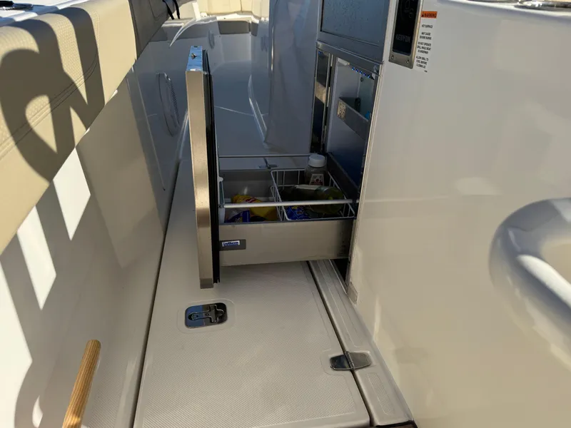 Slide: The Image of 2019 Pursuit S 368 Sport boat interior with open storage compartment. - 8