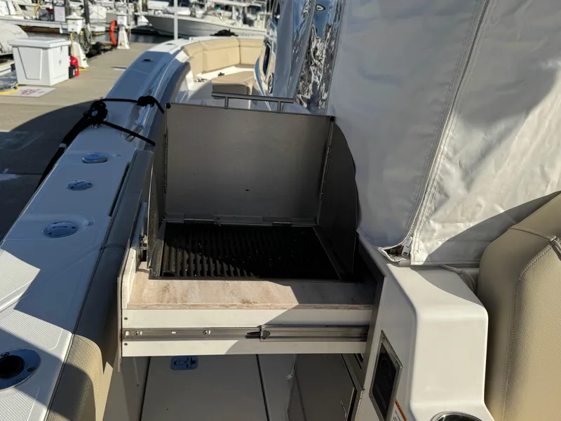 Slide: The Image of 2019 Pursuit S 368 Sport boat with built-in grill on deck. - 9