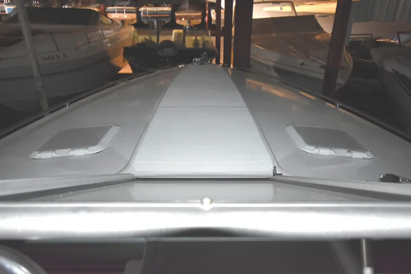Slide: The Image of 1997 Formula 330 Sun Sport boat docked in a dimly lit marina. - 2