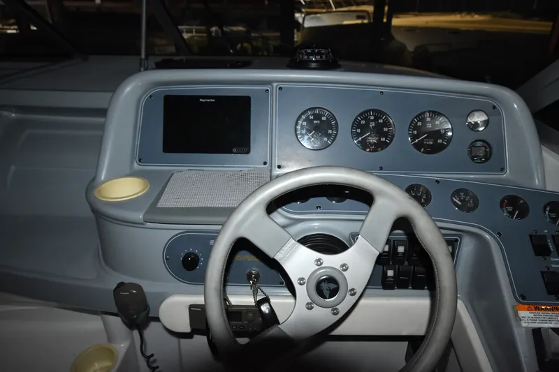Slide: The Image of Dashboard of a 1997 Formula 330 Sun Sport boat with steering wheel and gauges. - 21