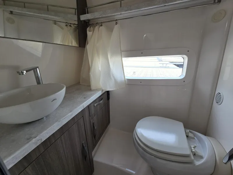 Slide: The Image of Bathroom interior of 2020 Regal 33 XO boat with modern sink and toilet. - 13